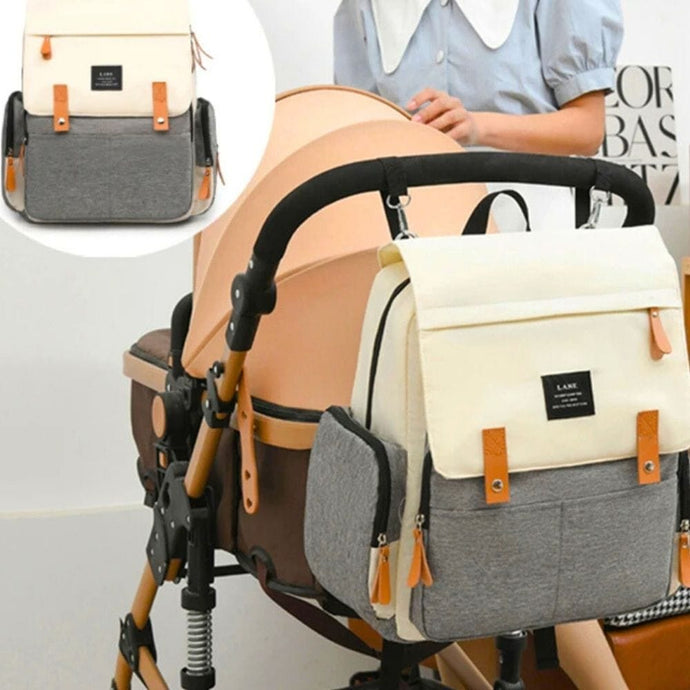 Sac à langer bébé avec plusieurs poches de rangement, s'attache facilement à la poussette.